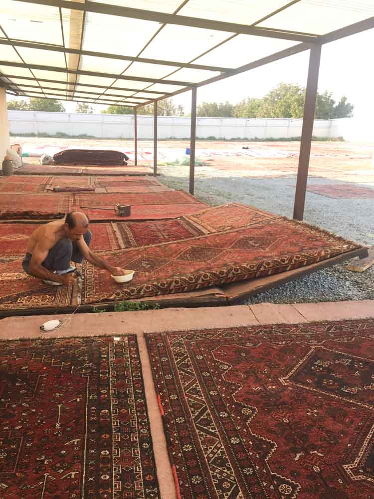 Finishing Touches To Handknotted Rugs Before Coming To Yashar Bish